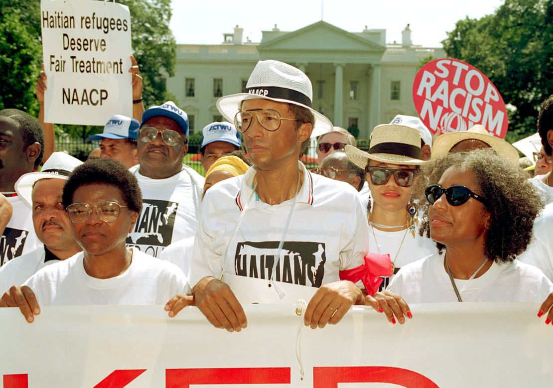 Ashe takes part in a demonstration outside the White House in 1992, protesting the Bush administration's policy on Haitian refugees. He was later arrested during the protest.