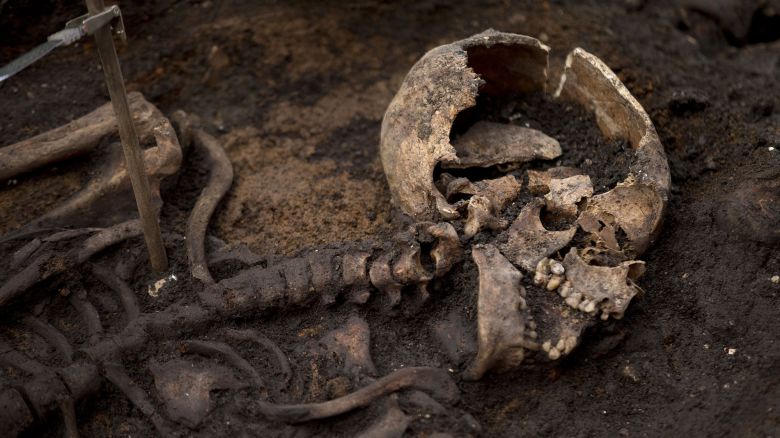 A skeleton lies in the ground on the archeological excavation site at the 16th and 17th century Bedlam burial ground, uncovered by work on the new Crossrail train line next to Liverpool Street station in London, Friday, March 6, 2015. The excavation team estimate there to be 3,000 human skeletons at the site, which was a burial ground to the then adjacent Bedlam Hospital, the world's first psychiatric asylum. The 118-kilometer (73-mile) Crossrail project to put a new rail line from west to east London is Britain's biggest construction project and the largest archeological dig in London for decades. (AP Photo/)