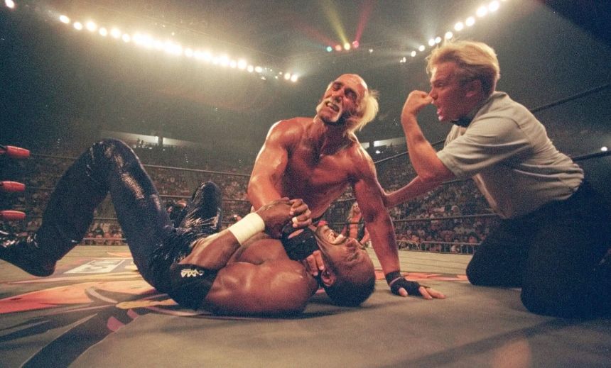 Hollywood Hulk Hogan puts a choke hold on the neck of Utah Jazz basketball star Karl Malone at a pay-per-view wrestling match Sunday July 12, 1998 in San Diego.