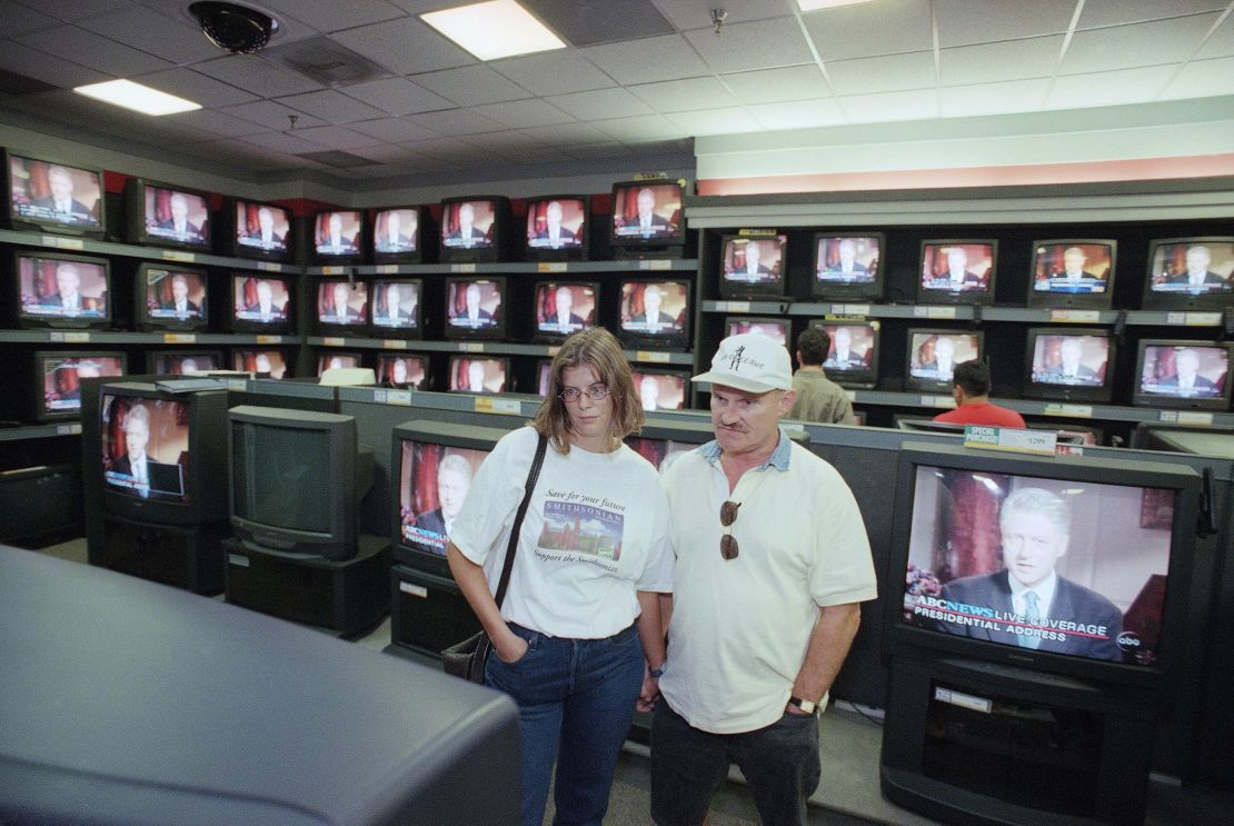 Dorthe Thomas and Harry Smallenburg view President Bill Clinton's speech about Monica Lewinsky on August 17, 1998, at an electronics store in Pasadena, California.