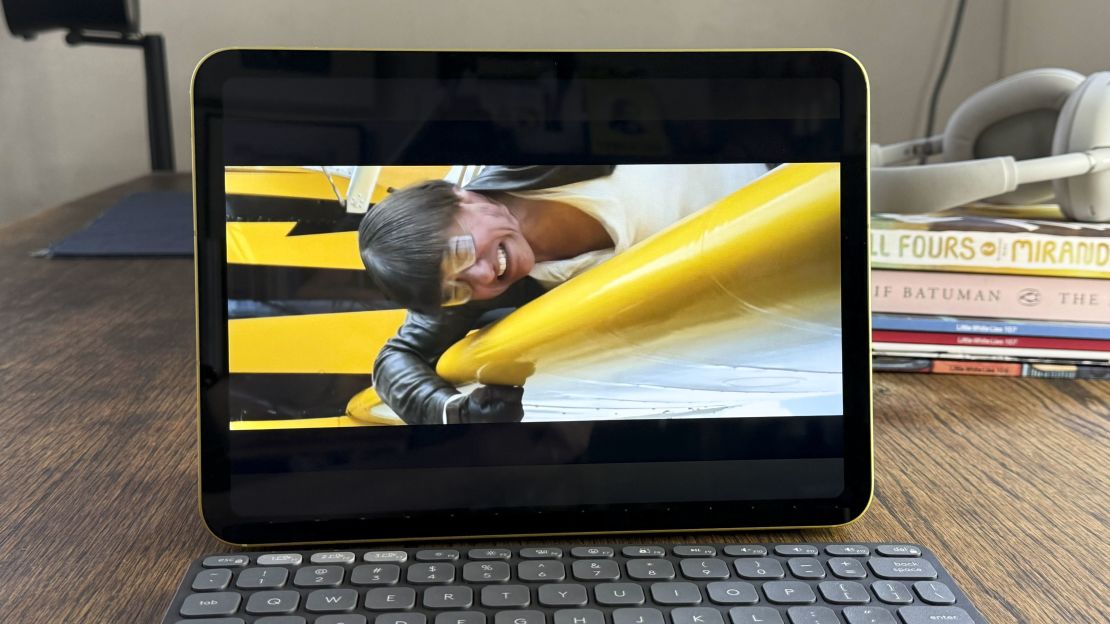 The iPad 11 shows the trailer for a mission: impossible movie where Tom Cruise is holding onto an airplane while the winds push his hair down