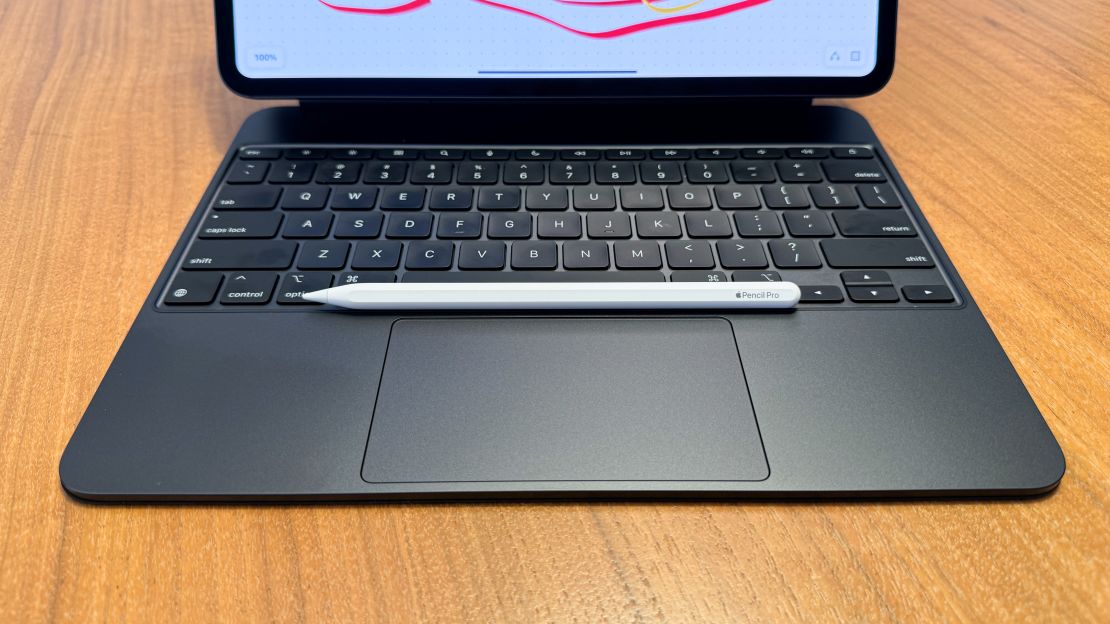 The Apple Pencil Pro sits on the Magic Keyboard for iPad Pro