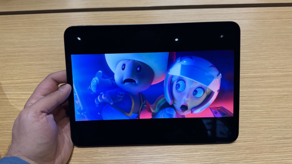 A hands holds an Apple iPad Pro M4 showing a scene from The Super Mario Bros. Movie where Toad and Peach are shocked