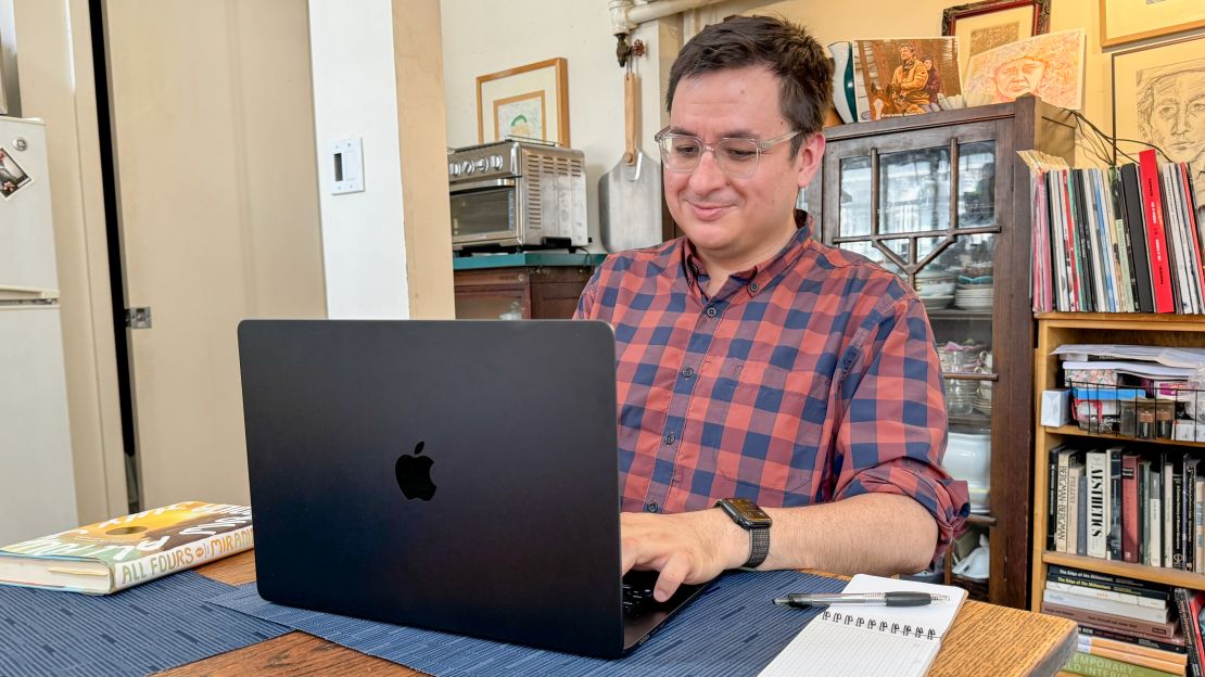 The author is typing on a dark Apple MacBook Pro 15-inch.