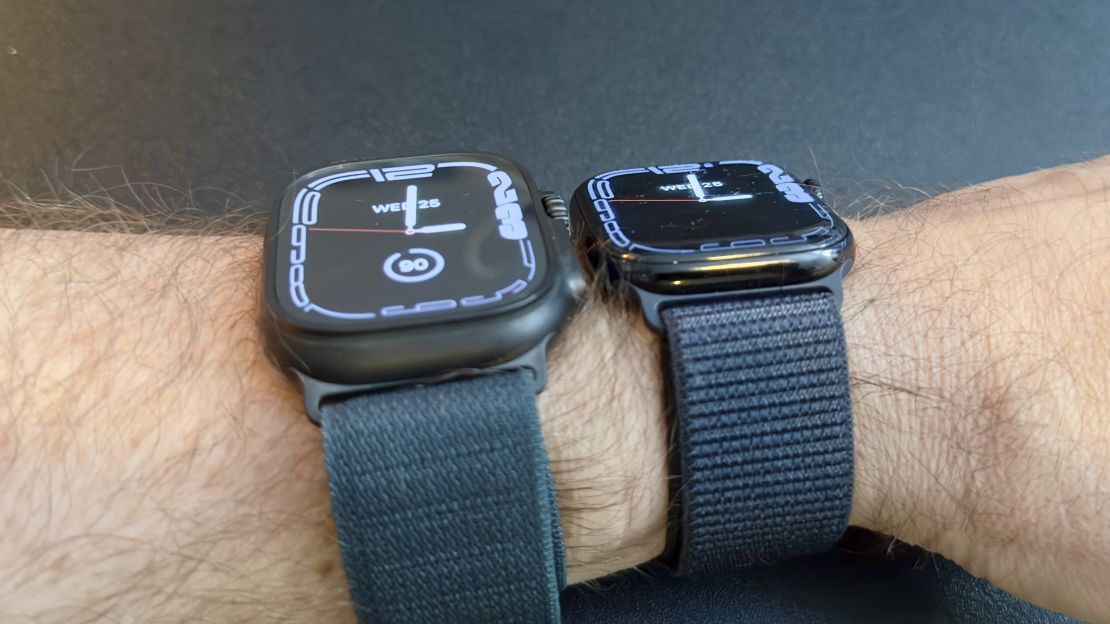 Two smartwatches next to each other on wrist.