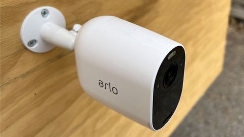 The Arlo Essential Wireless Security Camera, mounted on a sheet of plywood