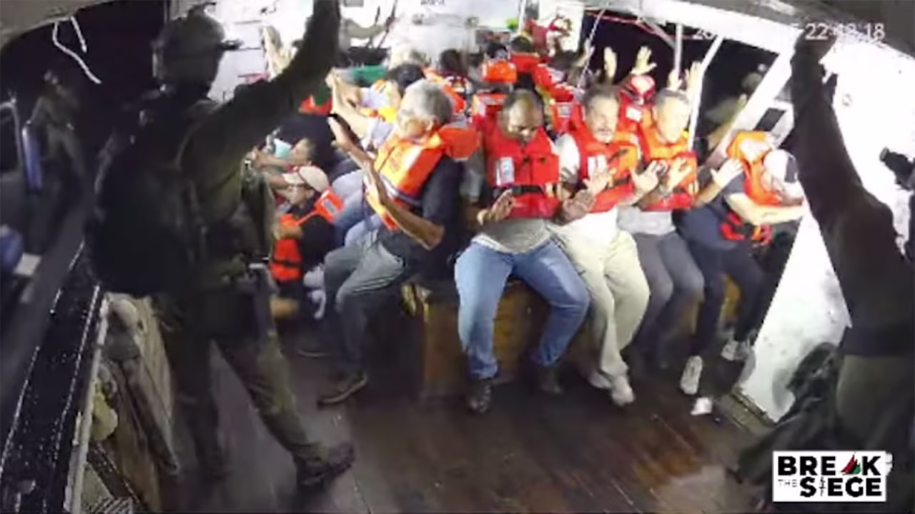 A still from a livestream shows armored personnel intercepting the Handala, with those aboard surrendering immediately.
