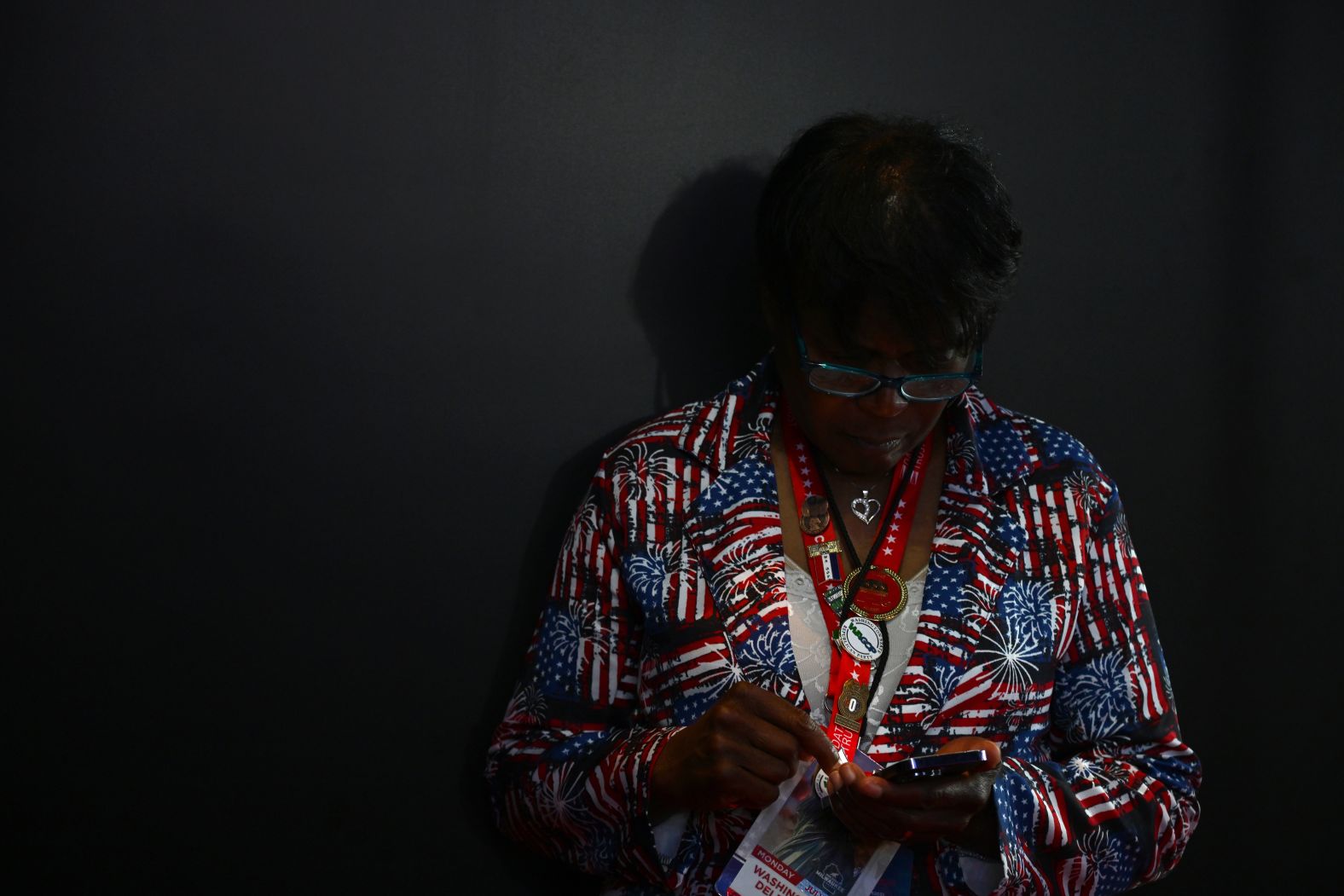 A delegate checks her cell phone inside the Fiserv Forum on Monday.