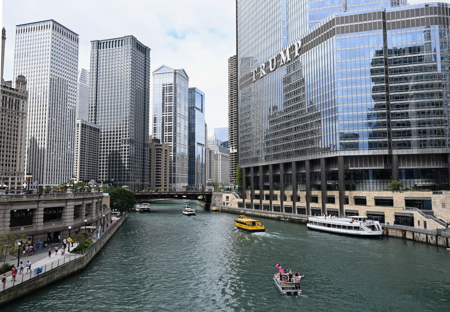 A boat carrying pro-Palestinian protesters, bottom, travels along the Chicago River on Sunday.