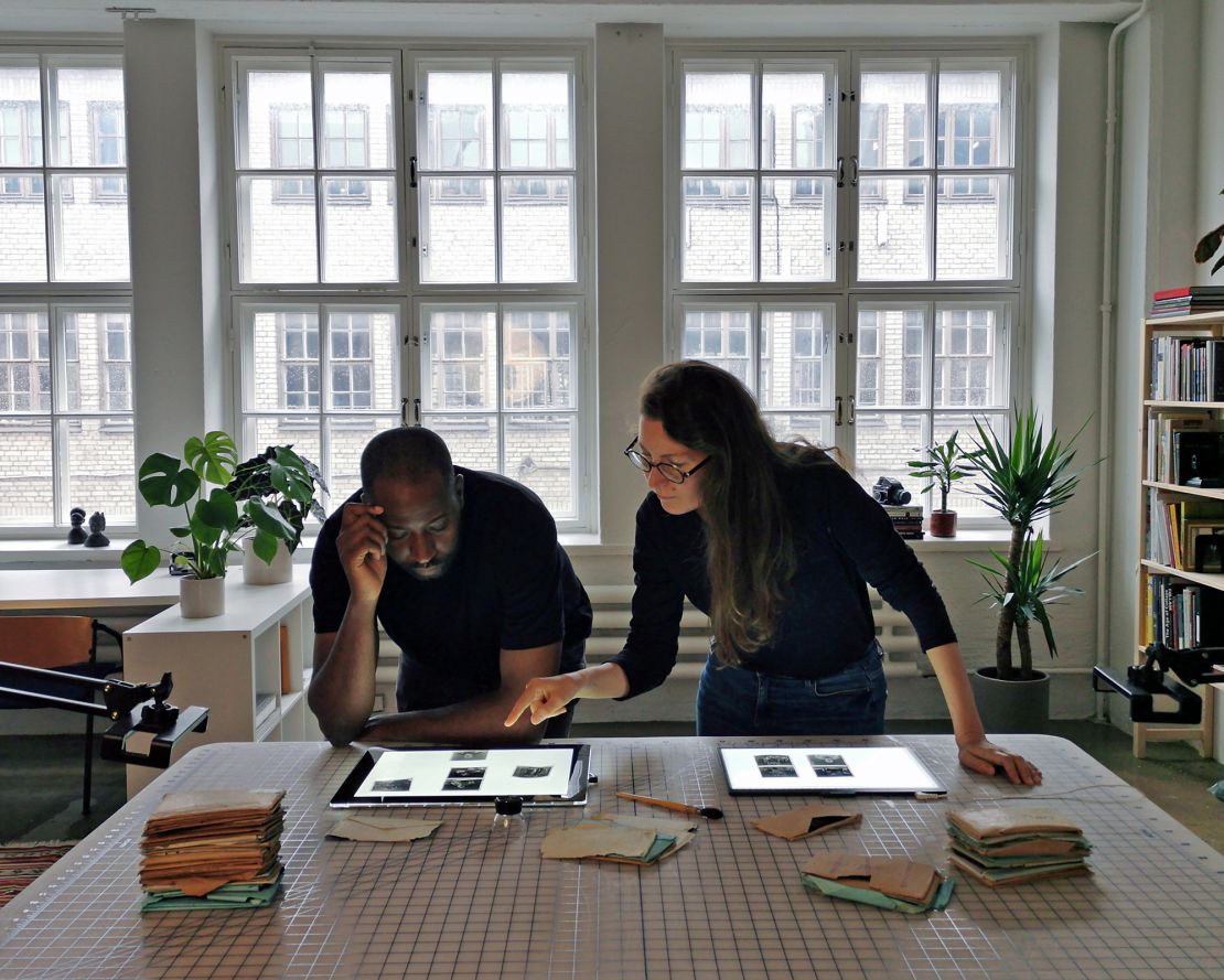 Karl Ohiri and Riikka Kassinen going through negatives in their studio in Helsinki, Finland.