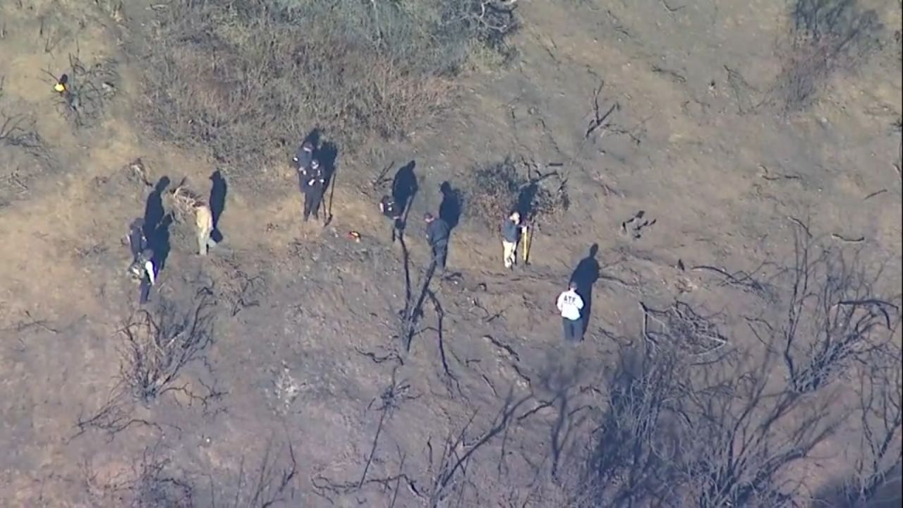 ATF teams investigate in the hills above the Pacific Palisades on Tuesday.