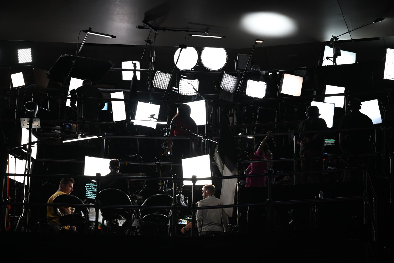 Media members work at the convention on Monday.