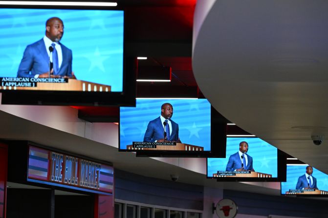 US Sen. Raphael Warnock is seen on United Center screens as he gives a speech on Monday.