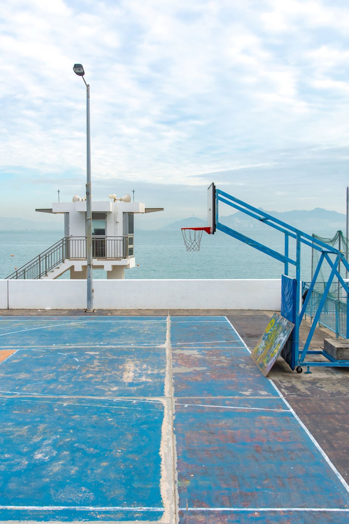 A blue basketball court on Cheung Chau, one of Hong Kong’s islands, matches the coast.