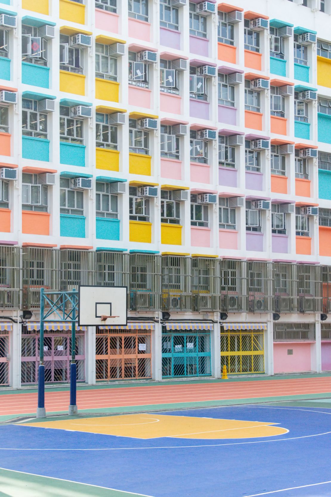 The majority of Hong Kong’s outdoor basketball courts are located in schools, and often double as playgrounds for recess.