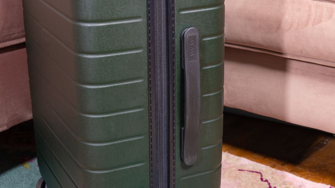 A photo of the side of a green Away The Carry-On bag