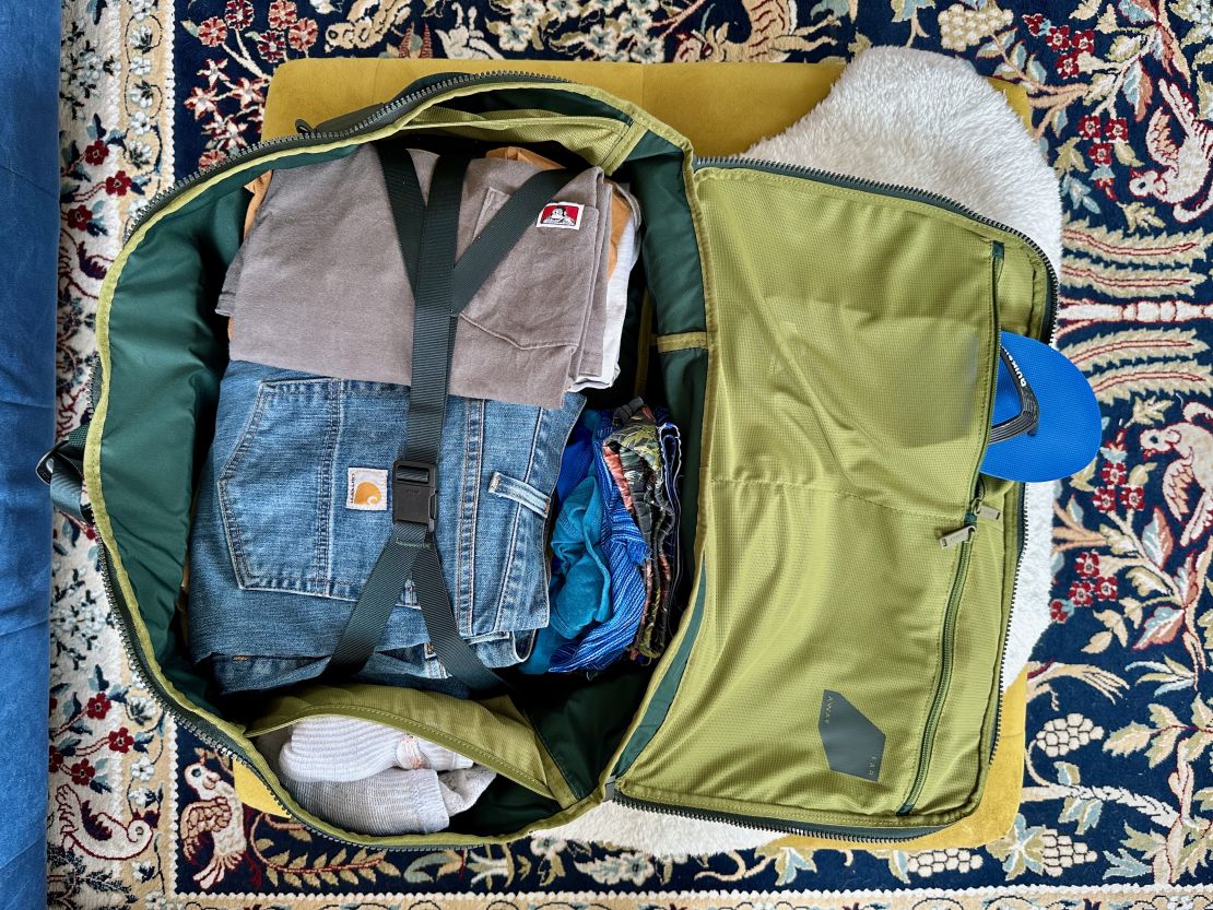 A photo of the Away F.A.R. backpack packed for a trip to Chicago