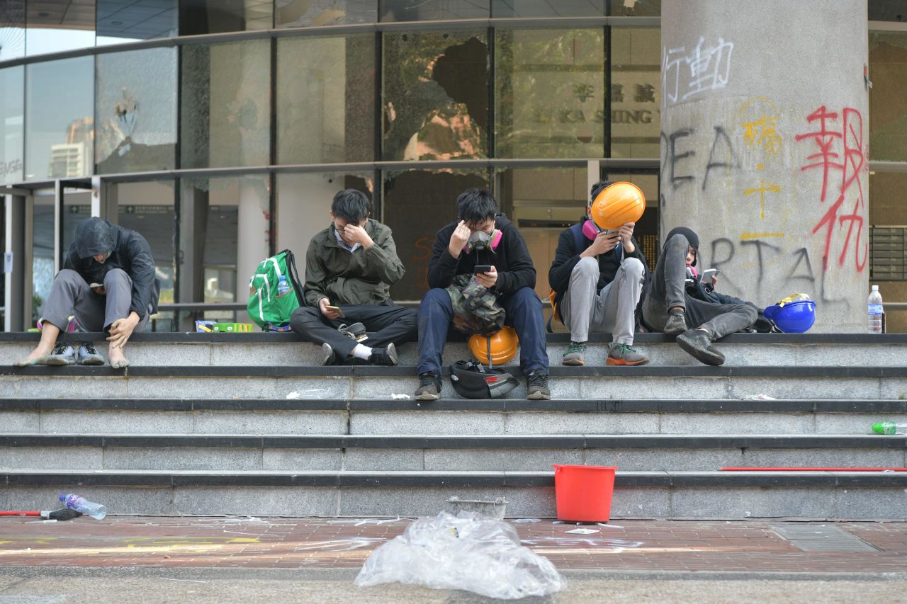 A group of protesters rest on stairs after unable to find safe passage out of Hong Kong Polytechnic University in Hung Hom district of Hong Kong on November 18.