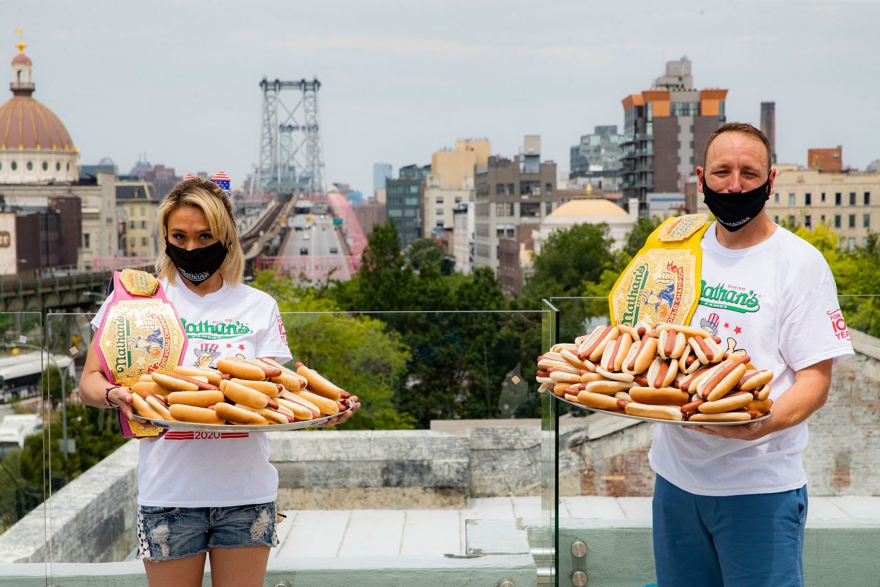 Competitive eaters Miki Sudo, left, and Joey Chestnut, right, pose for a photograph at the weigh-in the day before the Nathan's Famous July Fourth hot dog eating contest on July 3 in New York. 