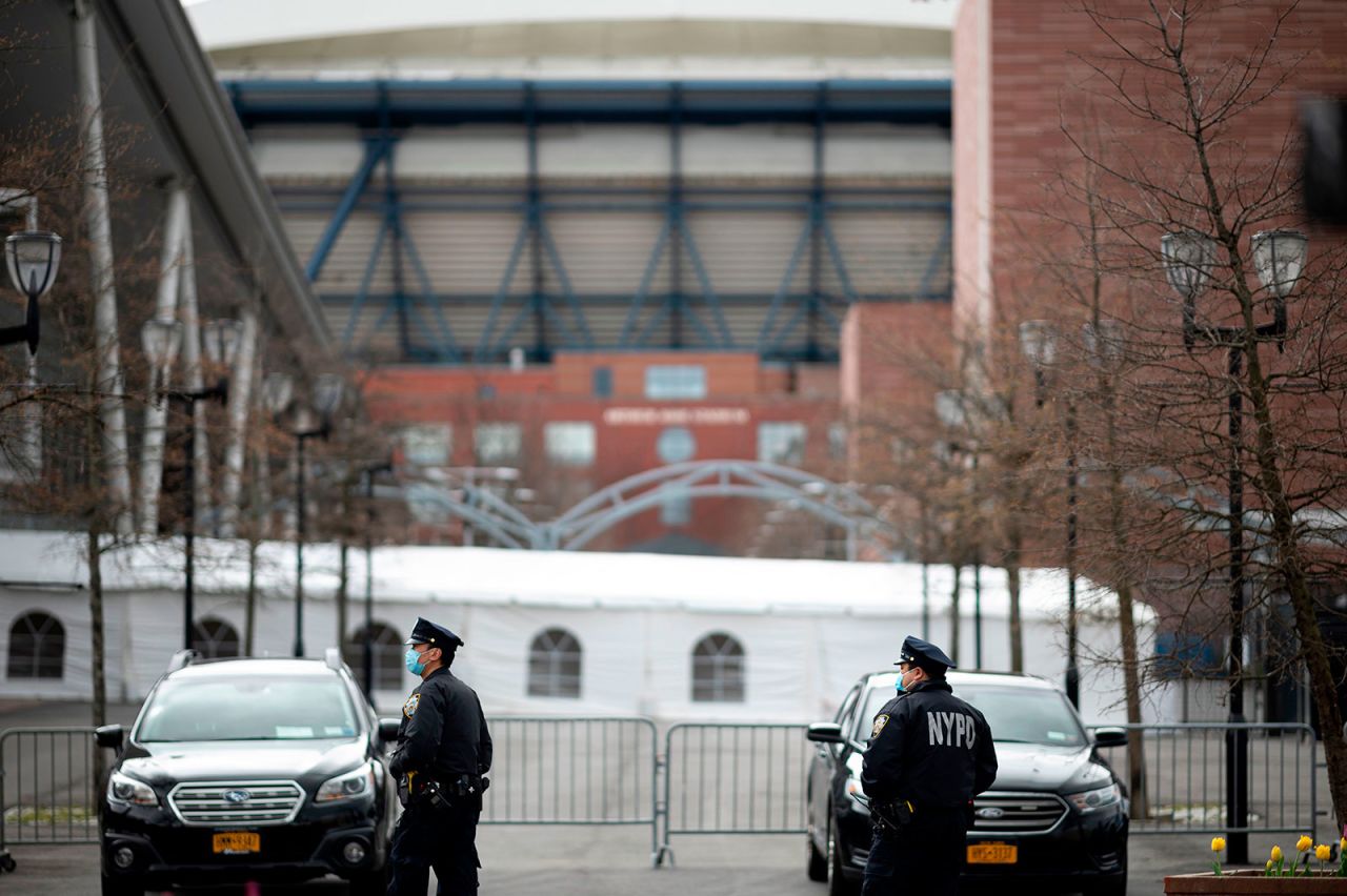 NYPD officers stand outside a temporary hospital located at the USTA Billie Jean King National Tennis Center in Queens, New York, on April 10.