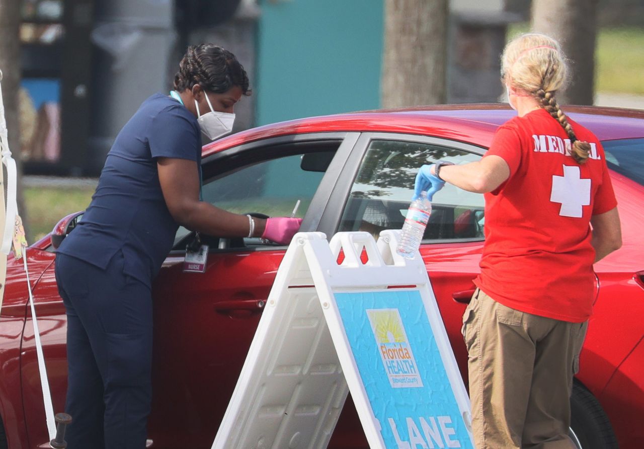 A healthcare worker with the Florida Department of Health in Broward prepares to administer a COVID-19 vaccine at a drive-thru vaccination site in Davie, Florida, on Tuesday, January 4. 