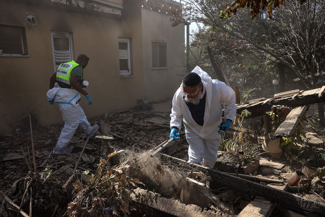 Volunteers from Israeli volunteer-run emergency rescue service ZAKA search through debris in Be'eri, a kibbutz near the border with Gaza, on October 20.