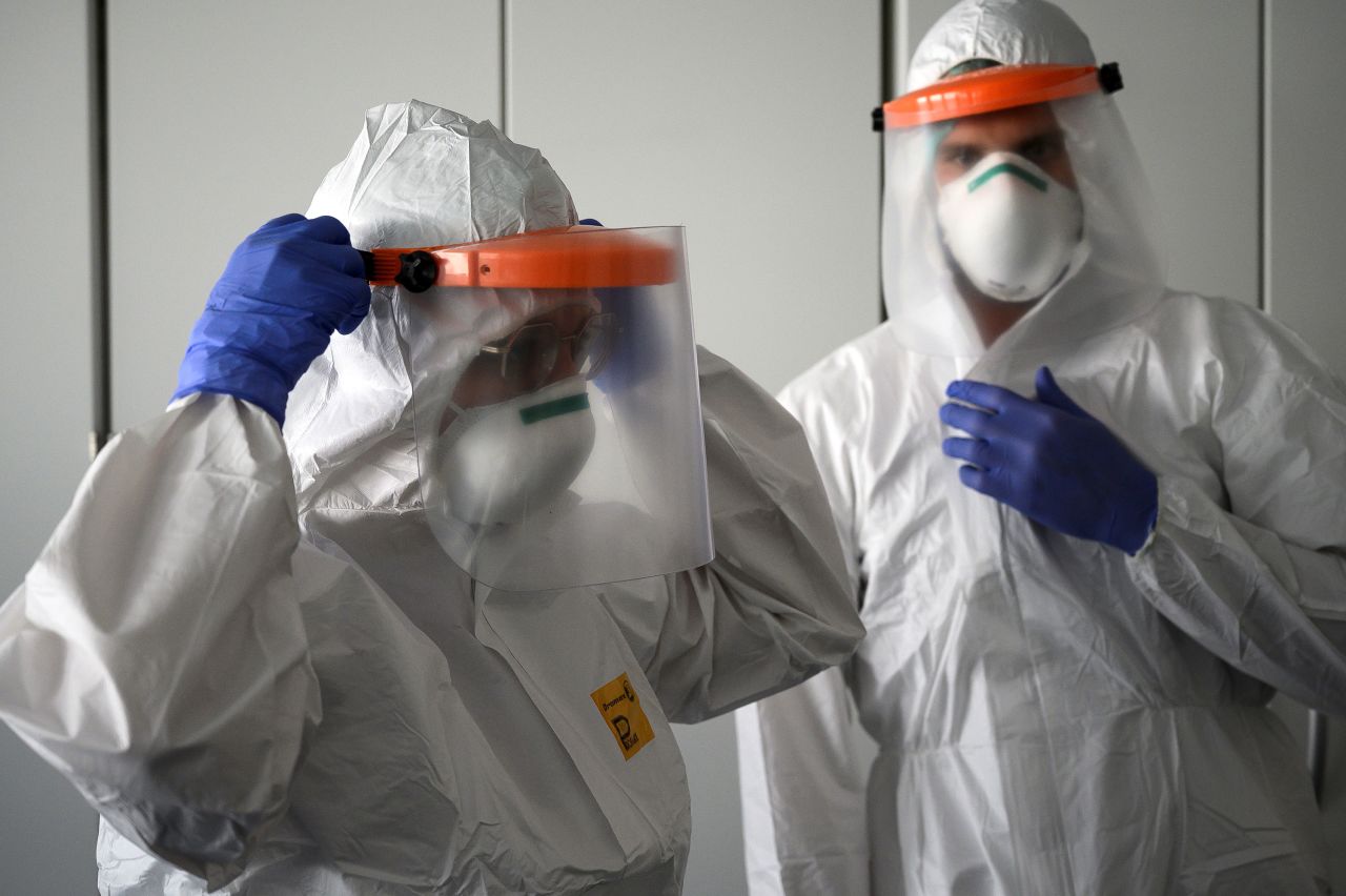 Nurses put on personal protective equipment before starting work in the intensive care unit of the new Covid-19 Hospital in Verduno, Italy on March 29.