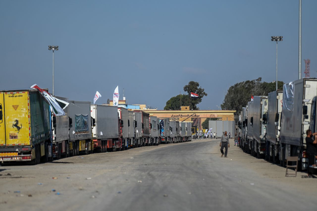 Trucks loaded with humanitarian aid wait in front of the Rafah border crossing on Friday.