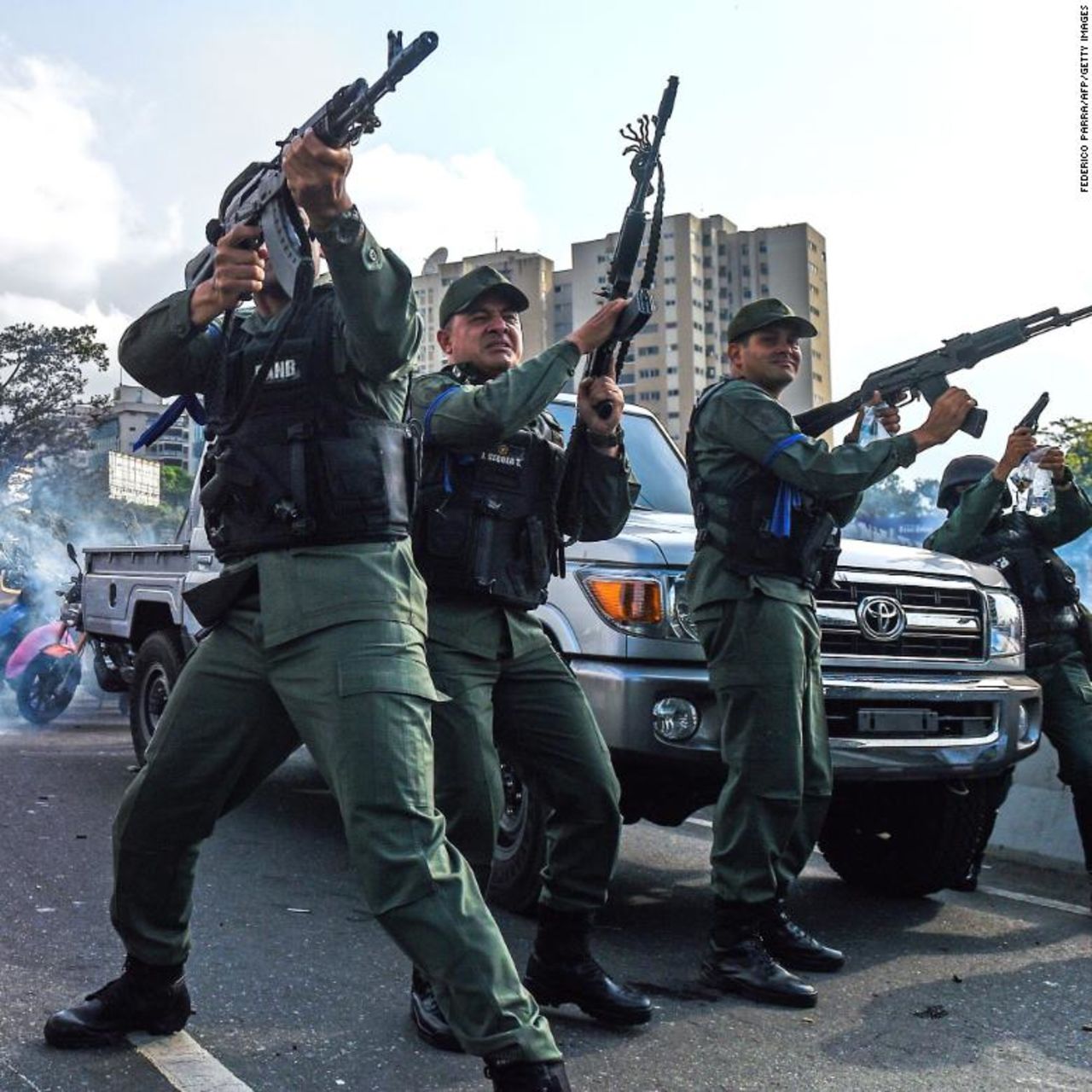 Members of the Bolivarian National Guard who joined Venezuelan opposition leader and self-proclaimed acting president Juan Guaido fire into the air to repel forces loyal to President Nicolas Maduro who arrived to disperse a demonstration near La Carlota military base in Caracas.