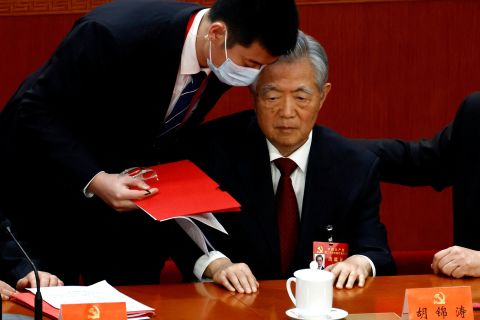 Hu Jintao is assisted at his seat during the closing ceremony of the 20th Party Congress in Beijing on October 22.