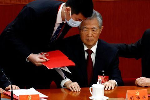 Hu Jintao is assisted at his seat during the closing ceremony of the 20th Party Congress in Beijing on October 22.