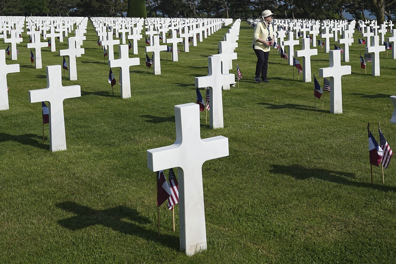 A woman walks past crosses and flags at an US cemetery near Colleville-sur-Mer, Normandy, on June 6.