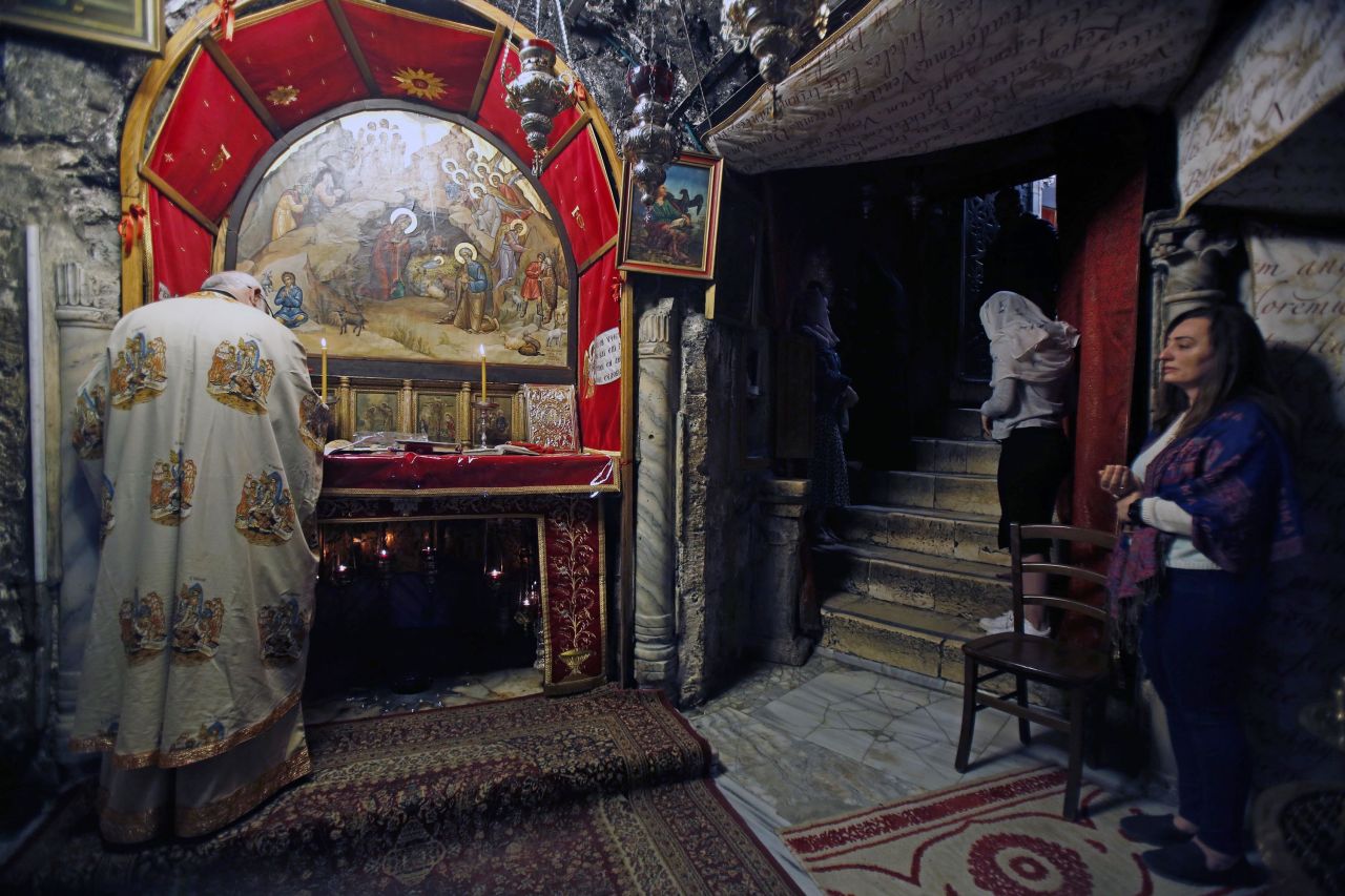 Worshippers pray in the Grotto of Bethlehem's Church of the Nativity, following its reopening in the West Bank, on Tuesday, May 26.