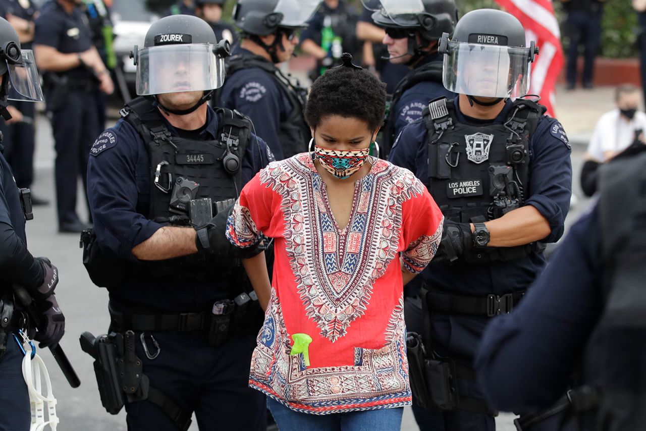 A protester is arrested for violating a curfew on Monday, June 1, in the Hollywood area of Los Angeles.