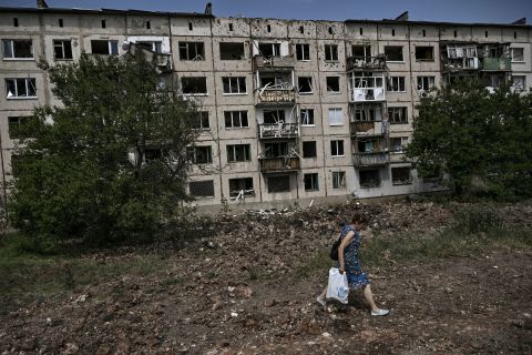 A woman walks in front of a damaged apartment building after a missile strike in the city of Soledar, eastern Donbas, on Saturday.