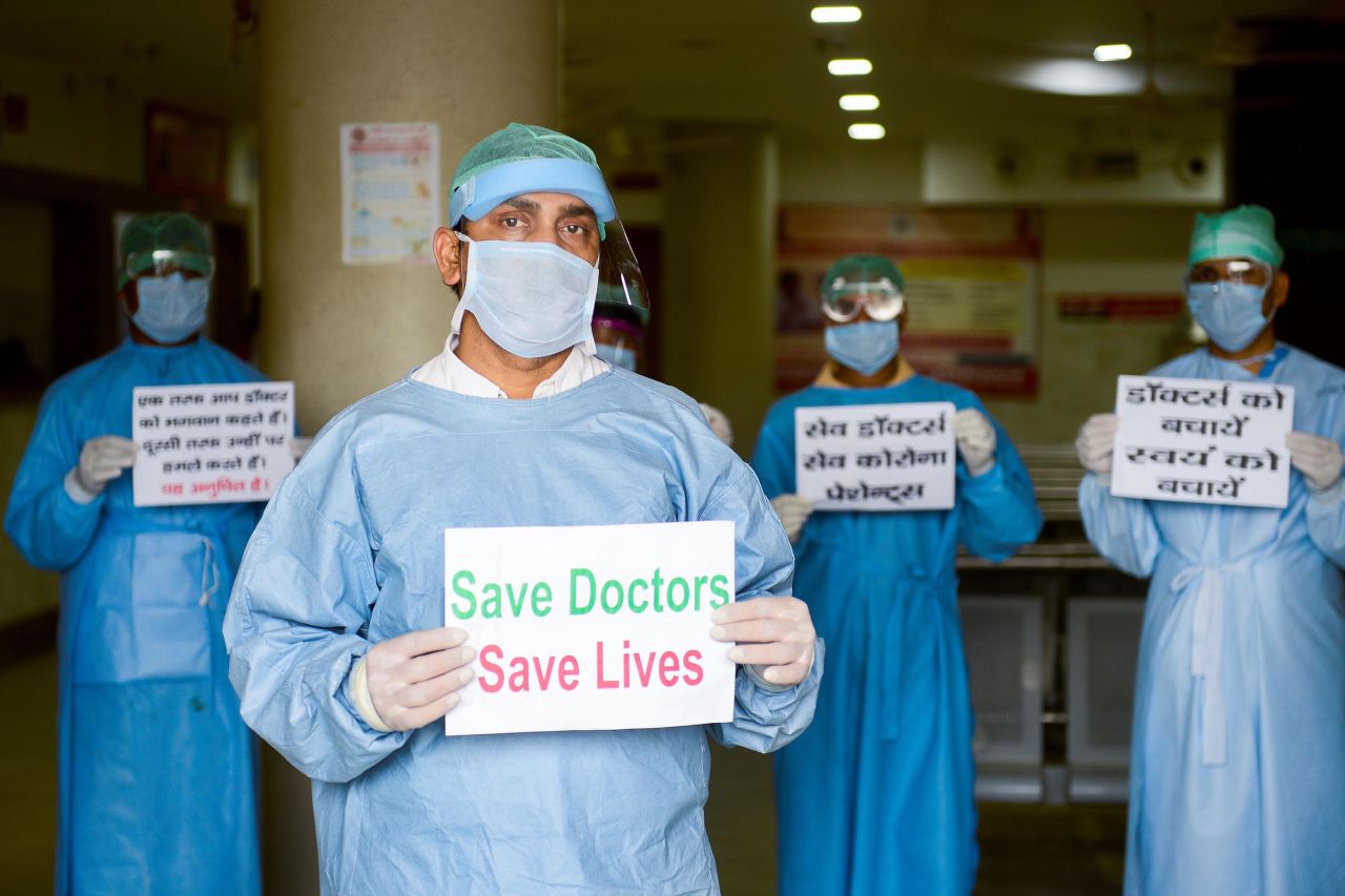 Doctors and medical staff of Narayan Swaroop Hospital in Allahabad hold placards to protest against recent assaults on health workers in India, on April 16.