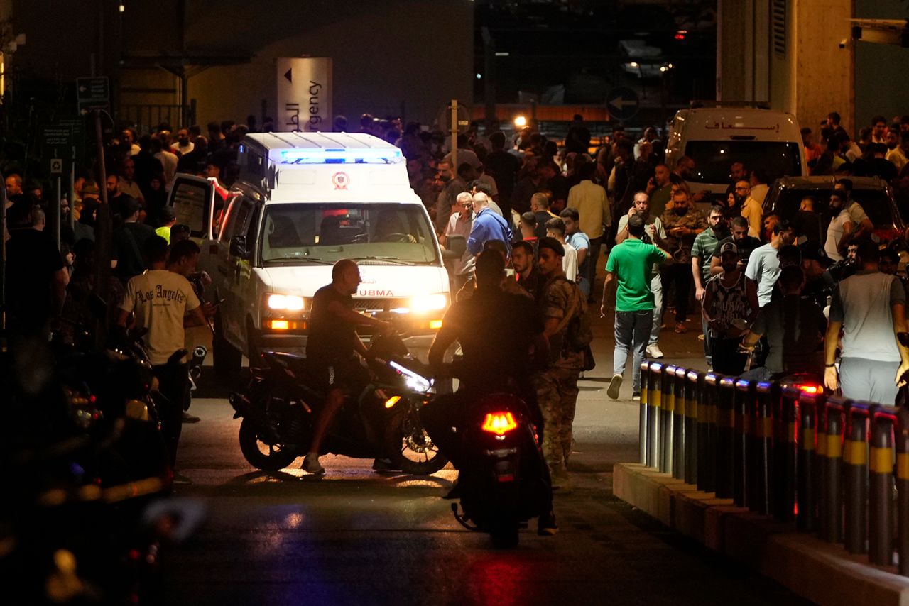 People gather around an ambulance carrying wounded people whose handheld pager exploded, at the emergency entrance of the American University hospital in Beirut, Lebanon, on September 17.