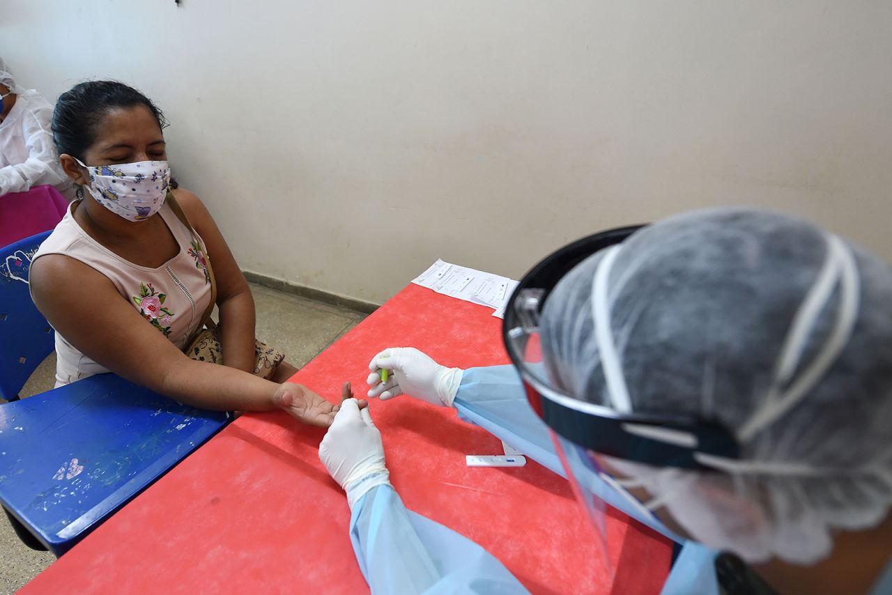 An Indigenous woman of the Marubo ethnic group is tested for Covid-19 by a member of the medical team of the Brazilian Armed Forces at a health post in Atalaia do Norte, Brazil, on June 20.