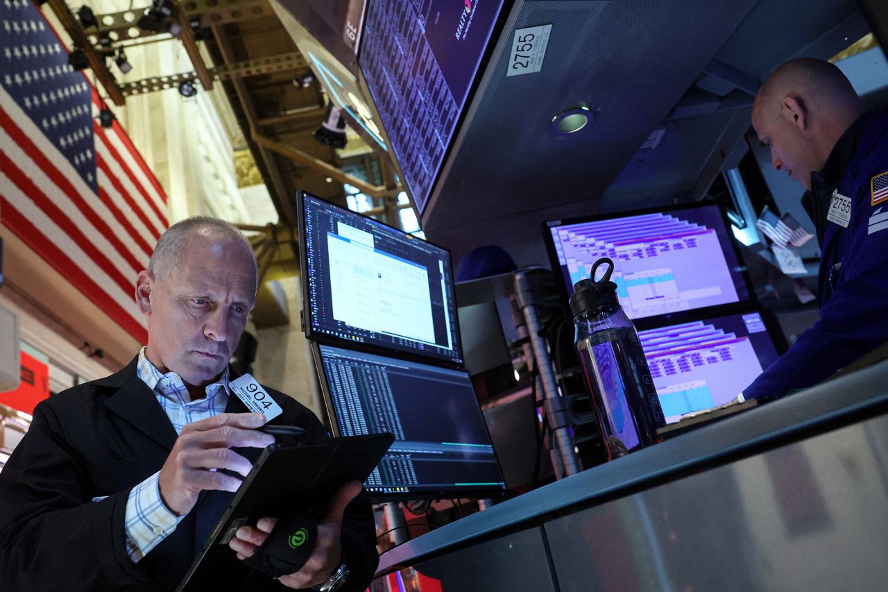 Traders work on the floor at the New York Stock Exchange today.