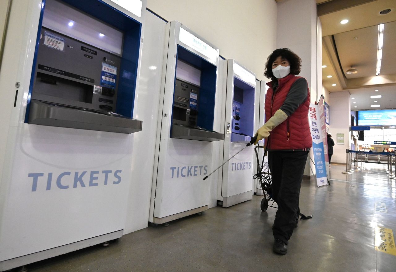 An employee sprays disinfectant at a railway station in Daegu.