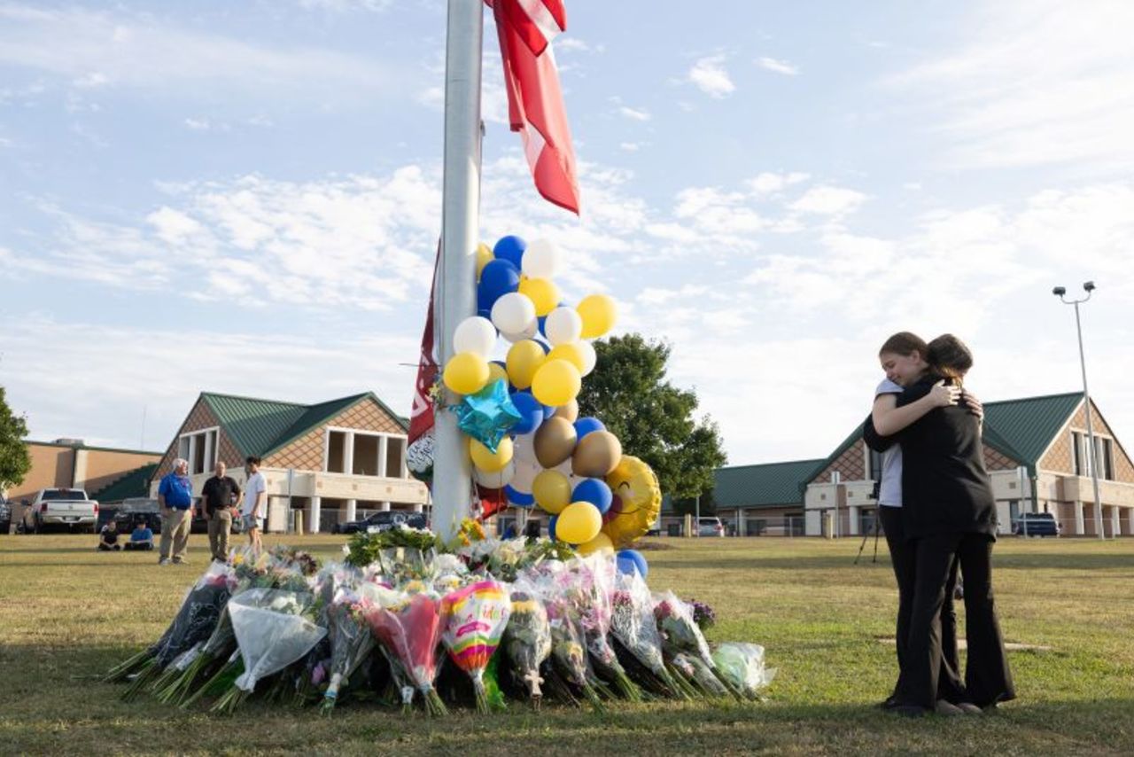 Students embrace near a makeshift memorial at Apalachee High School  in Winder, Georgia, on September 5.