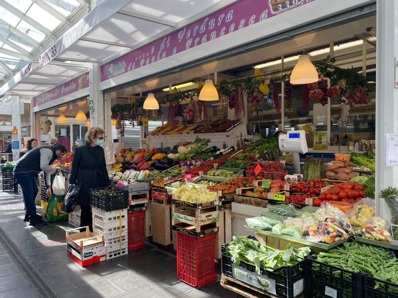 Customers in masks browse the Testaccio market in Rome on day two of Italy's lockdown.