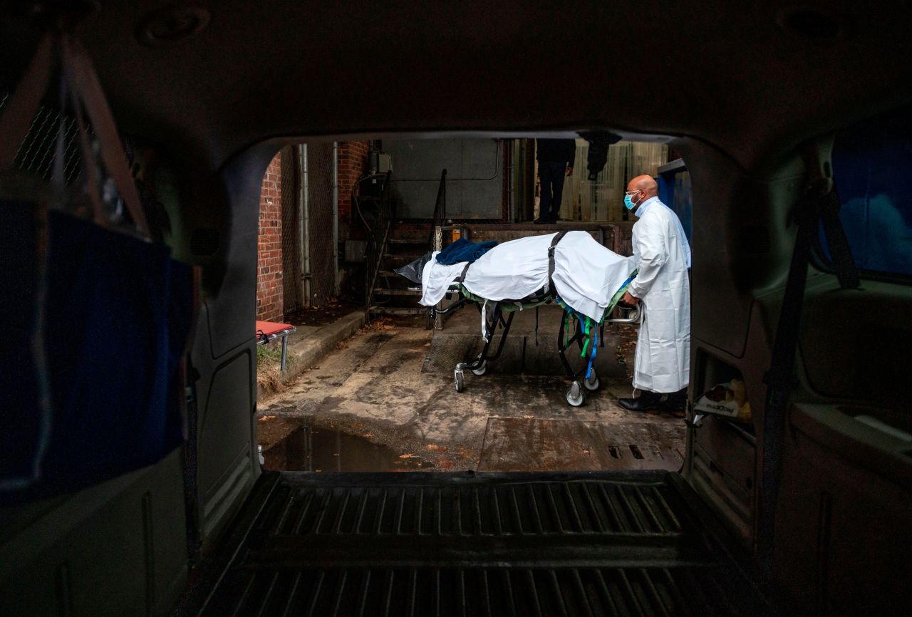 A Maryland Cremation Services transporter brings the body of a Covid-19 victim to his van from a hospital's morgue in Baltimore, Maryland, on December 24.