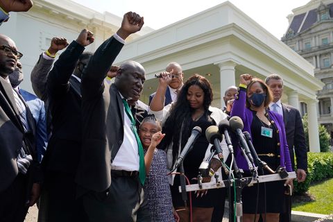 Benjamin Crump, front center, along with Gianna Floyd, daughter of George Floyd, and her mother Roxie Washington, and others talk with reporters after meeting with President Joe Biden at the White House, Tuesday, May 25.