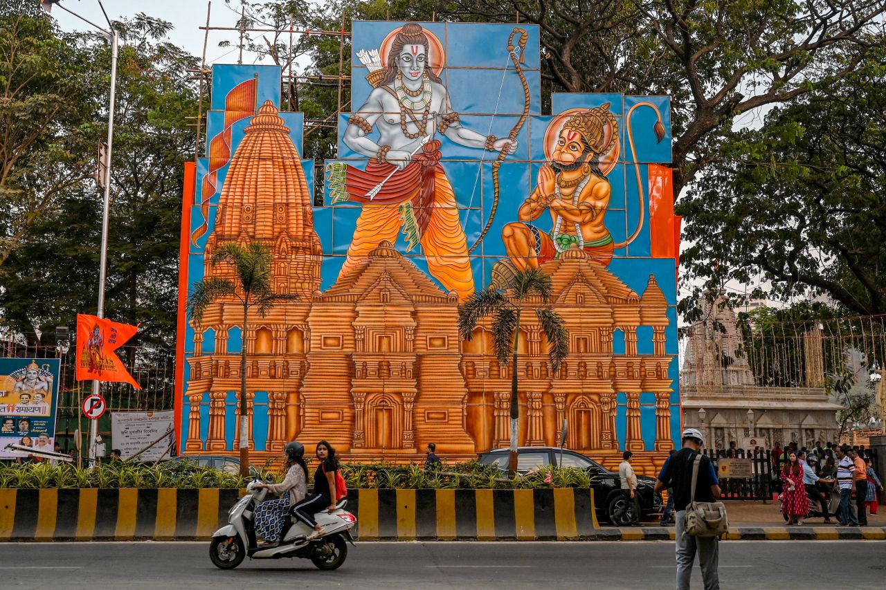 Vehicles ride past a billboard depicting Hindu deities Ram, left, and Hanuman, displayed along a street in Mumbai on January 17.