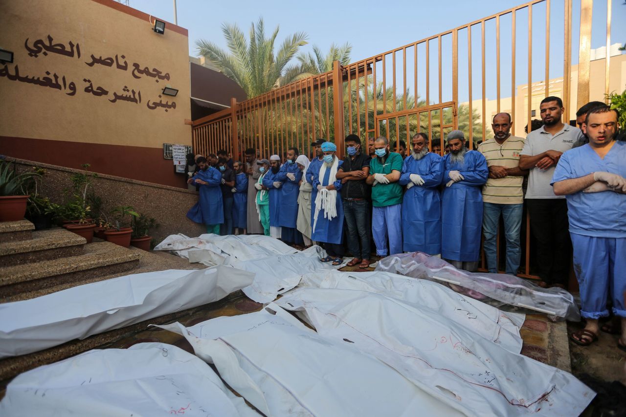 People mourn as they collect the bodies of Palestinians killed in Israeli air raids, on October 24, in Khan Yunis, Gaza.