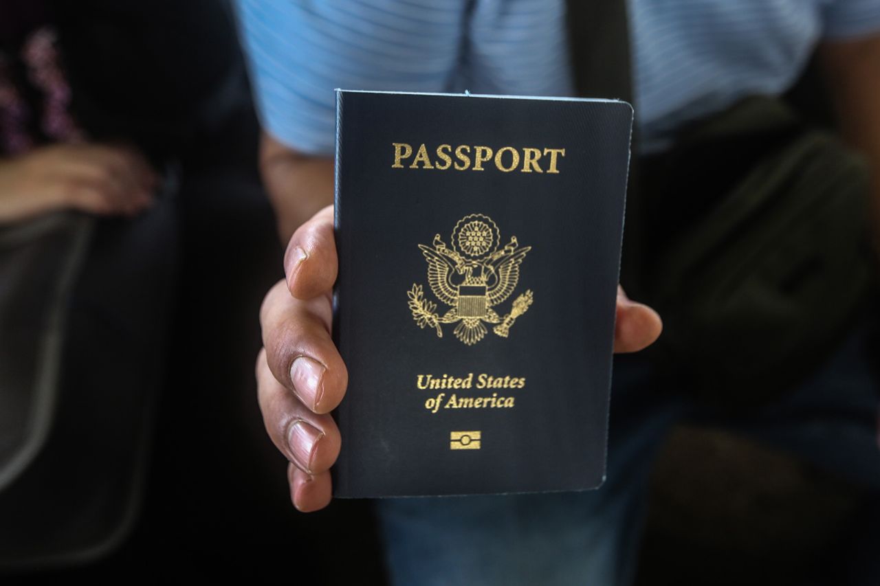 A US citizen holds his passport while waiting at the border crossing between Gaza and Egypt in Rafah, Gaza, on November 1.