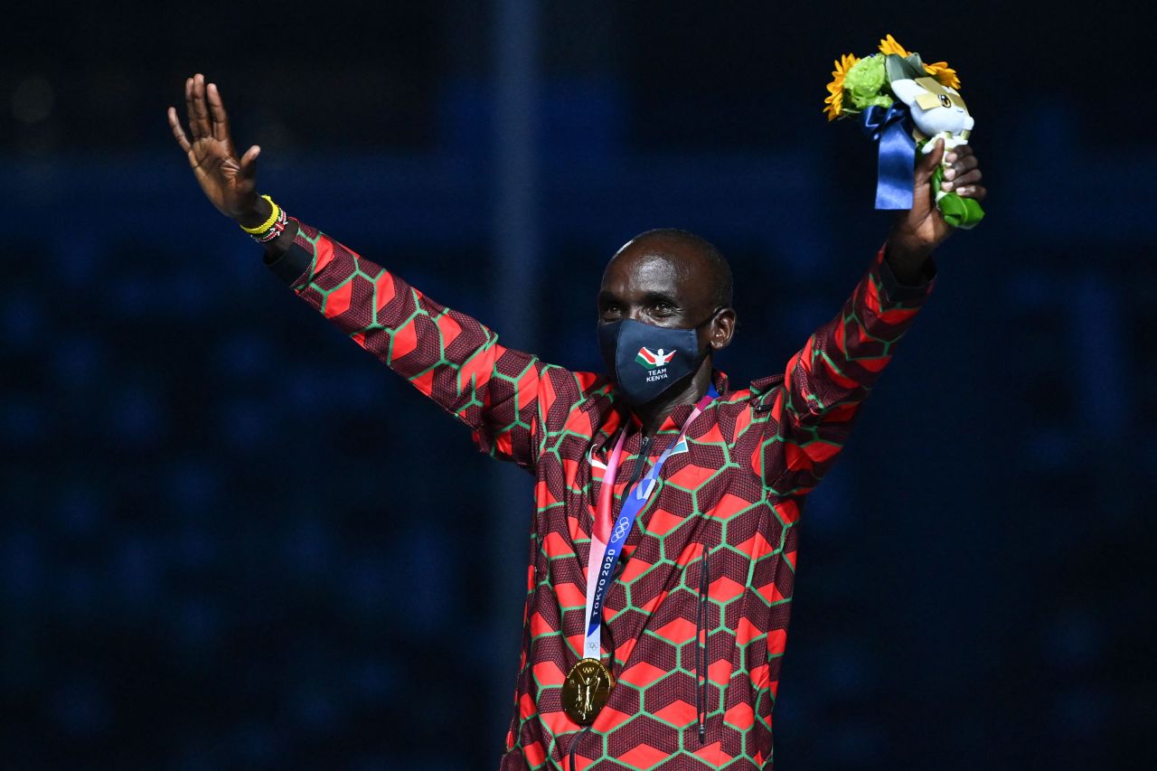 Marathon winner Eliud Kipchoge, from Kenya, celebrates on the podium during the closing ceremony.