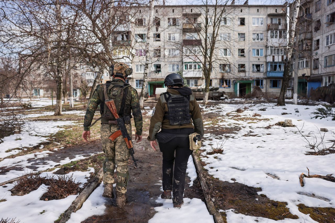 A Ukrainian soldier guides an Alaska State Sno-X Lions volunteer to a part of Chasiv Yar, where civilians remain in order to attempt to persuade them to evacuate, in the eastern region of Donetsk, Ukraine, on April 2.