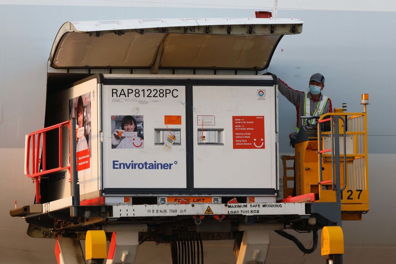 Workers unload containers of the Sinovac vaccine from an aircraft after it arrived from China at Hong Kong international airport on February 19.